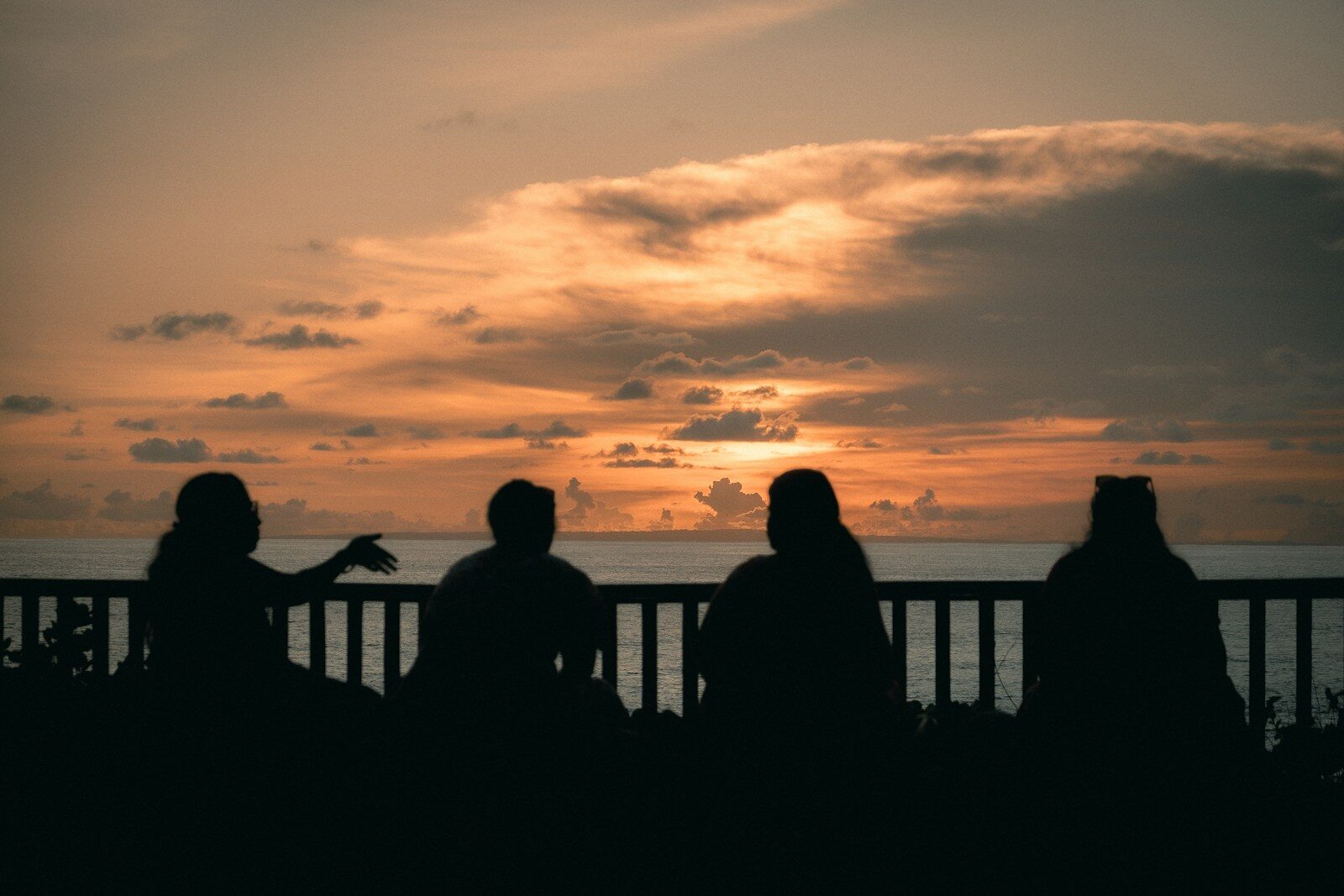 a group of people sitting on top of a balcony
